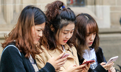 Students looking at their phones.