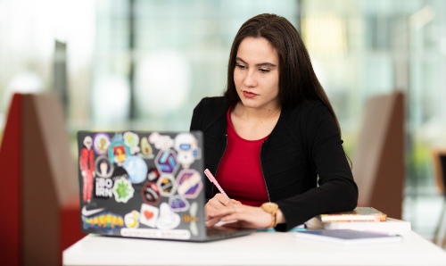 A female student sat working on her laptop.